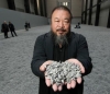 Ai holds some seeds from his Unilever Installation &quot;Sunflower Seeds&quot; at the Tate Modern in London. Since his arrest on April 3, Chinese authorities have publicly accused Ai of evading taxes on a company he controls, called Beijing Fake Cultural Development Ltd.