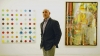 Art gallery owner Gary Nader stands in front of a Damien Hirst, &quot;Tixylix&quot;, left, and an Albert Oehlen, &quot;Sir Henry,&quot; right. Nader is launching an art auction house in Miami. Both paintings are up for sale at his upcoming auction.