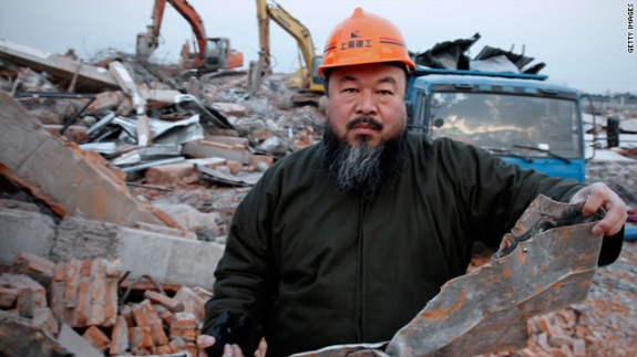 Chinese artist Ai Weiwei holds debris from his newly built Shanghai studio after the government demolished it without warning.