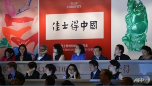  Staff take phone bids at a Christie&#039;s auction in Shanghai. 