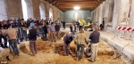 Cameras ready: Researchers dig into the underground tombs inside the convent while a crowd of media watches for discoveries