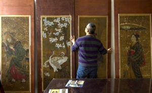 Conservator Yoshi Nishio with a few of the Japanese silk paintings he restored.