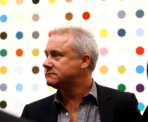 Damien Hirst in front of one of his spot paintings.
