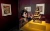 Qamar Adamjee, an organizing curator, looks at a Buddha.