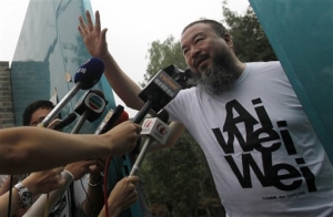 In this Thursday, June 23, 2011 file photo, activist artist Ai Weiwei opens the gate to talk to journalists gathered outside his home in Beijing, China. Liu Xiaoyuan, a close friend of Ai said Tuesday, June 28, 2011, Beijing&#039;s tax authorities are seeking nearly $2 million in back taxes and fines from the government critic who was recently released from detention.